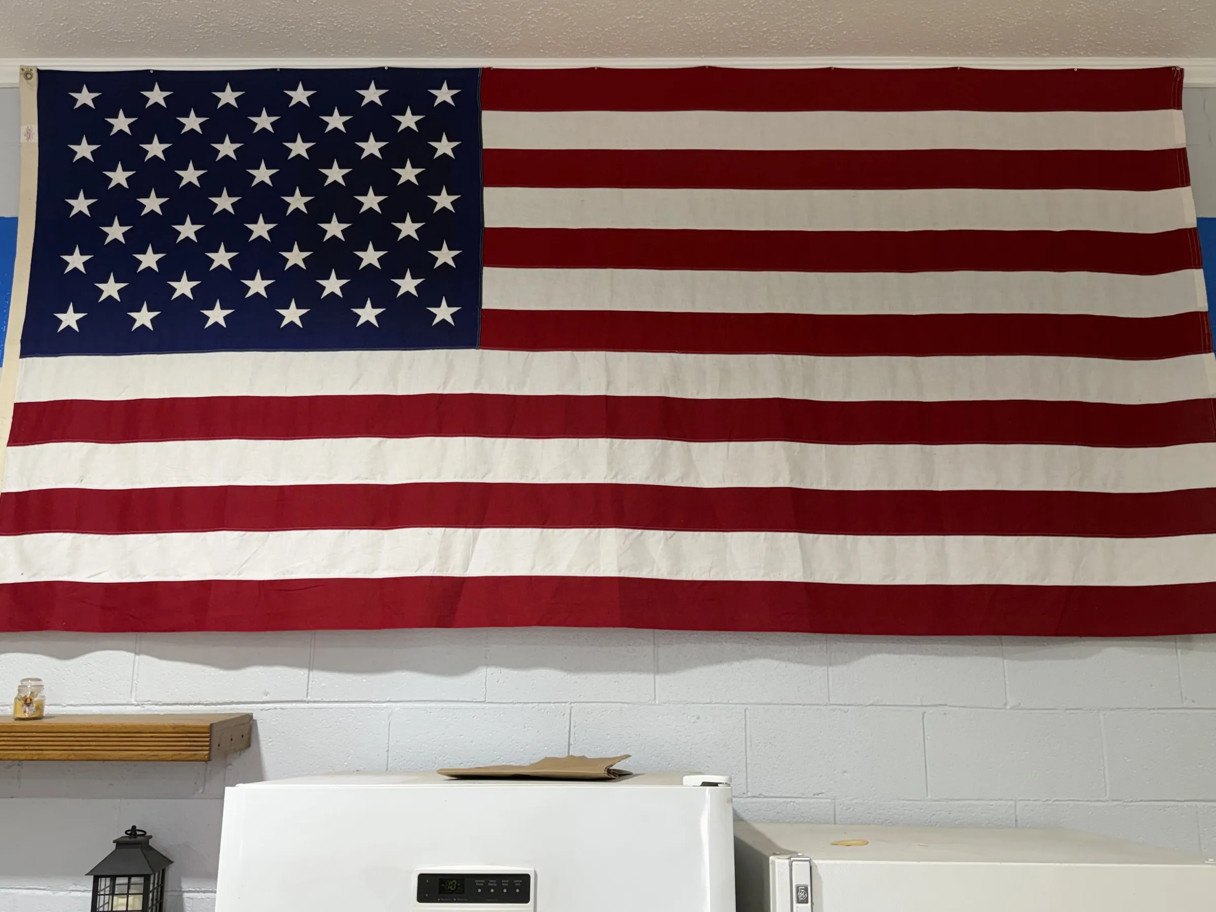 Large American flag hanging in the Baywood Search and Rescue station